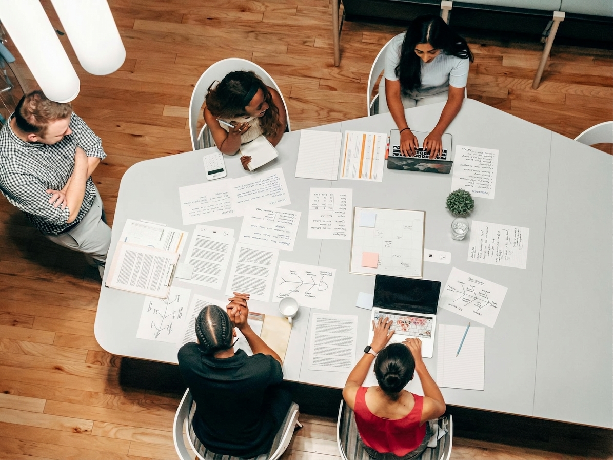 A small leadership workshop in progress — managers around a table mid-conversation